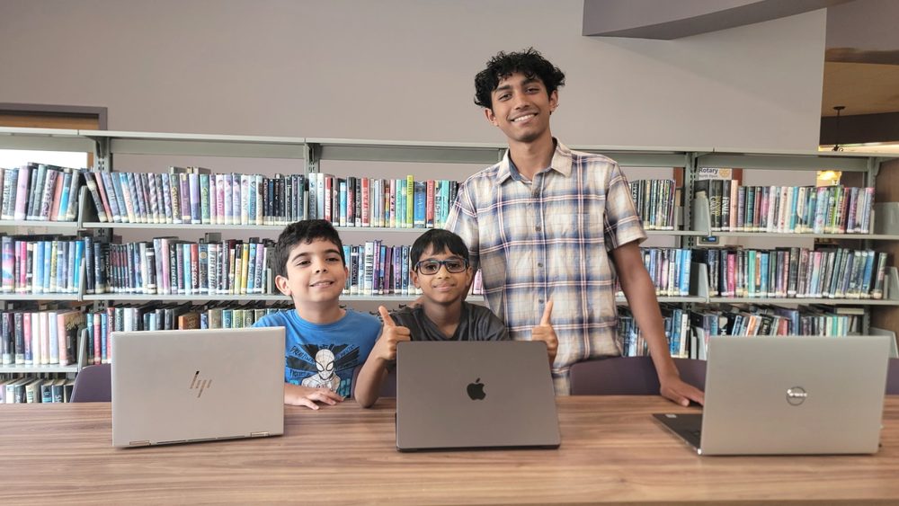 The end of a free AI class at North Wales Area Library, laptops still open on the table.